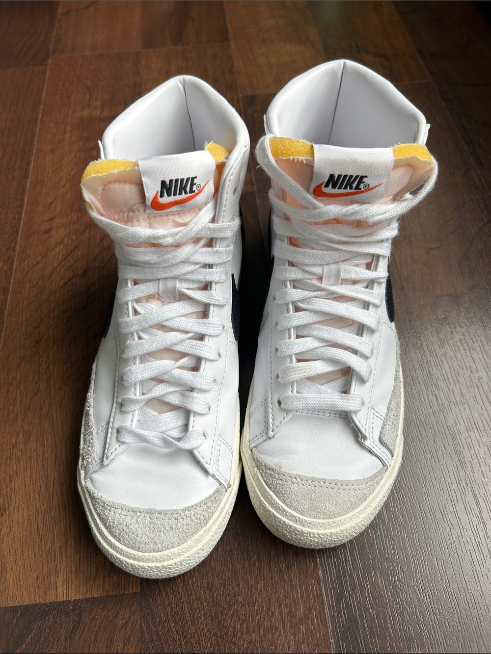 Nike White High-Top Sneakers with Black Swoosh and Yellow Accents